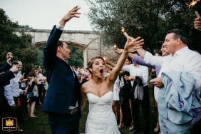At Domaine de Villary in Nimes, the bride enters with joy, her face beaming with happiness and excitement, arms raised in celebration.
